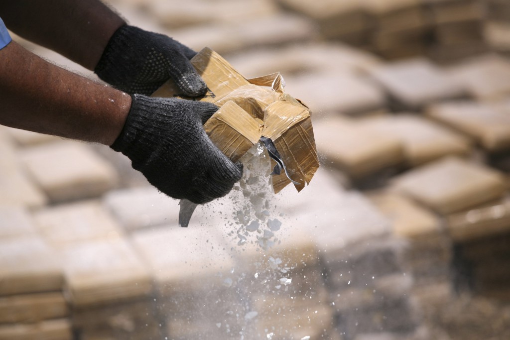 A policeman prepares seized drugs to be burned outside of Chinandega city