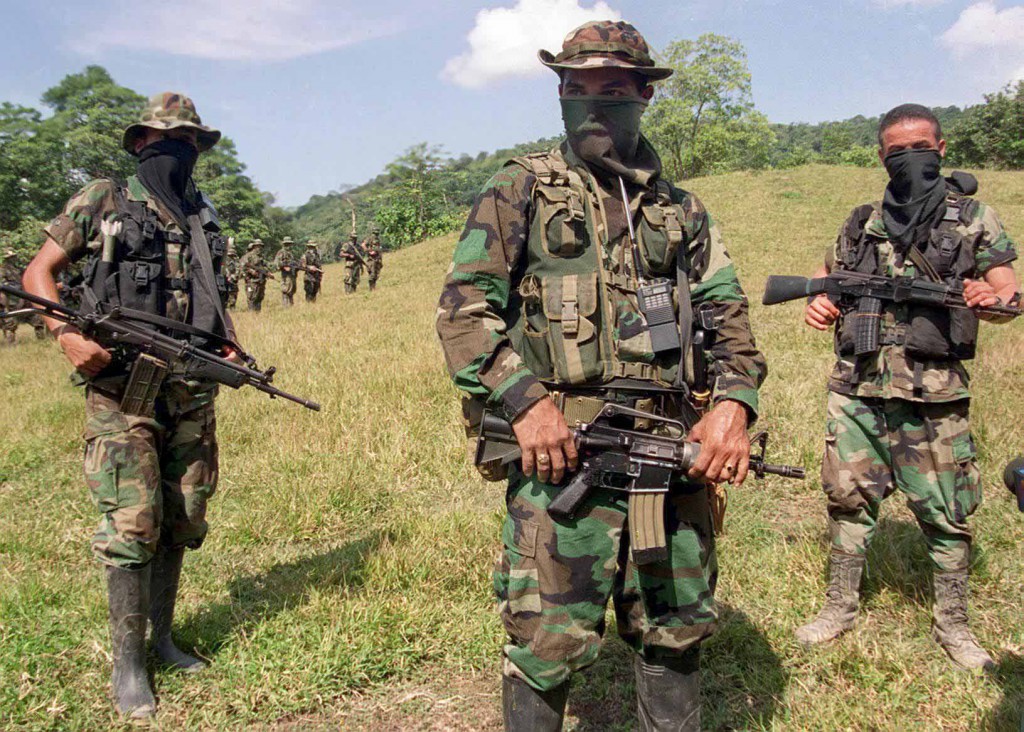 CATATUMBO, COLOMBIA - JANUARY 29:  Paramilitary leader of the Colombian United Self-Defense Forces (AUC) commandant Mauricio (C) trains his troops 29 January, 2000, in the mountains near Catatumbo, northwest of Bogota. Clashes between the AUC and guerrilla forces have been reported in the Catatumbo region, considered one of the major coca producing areas of Colombia.      Foto tomada el 29 de Enero de 2000 del comandate Mauricio (C), jefe militar del grupo paramilitar Autodefensas Unidas de Colombia, AUC, que operan en las montanas del Catatumbo, al noroeste de Bogota. Fuertes combates se han registrado las ultimas semanas entre las AUC y guerrilleros de las FARC y el ELN, por el control de la zona del Catatumbo, considerada una de las principales regiones productora de coca que sirve a financiar a las diferentes facciones que participan en el conflicto colombiano.  (Photo credit should read CARLOS GARCIA/AFP/Getty Images)