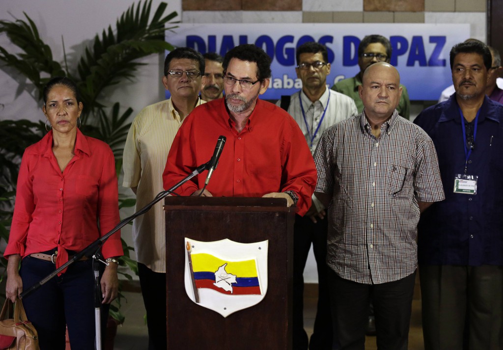 Revolutionary Armed Forces of Colombia (FARC) negotiator Pastor Alape (C) speaks to the media while flanked by fellow FARC members in Havana November 18, 2014. Colombia's rebels told a news conference on Tuesday they had no information about the kidnapping of a Colombian army general because of poor communication in the rural area where the government says he was abducted. Rebel leader Pastor Alape also said the Revolutionary Armed Forces of Colombia (FARC) remained committed to the two-year-old peace talks in Havana and hoped they would resume soon after President Juan Manuel Santos on Sunday suspended negotiations over what he said was the rebel kidnapping of General Ruben Dario Alzate.  Alape said. REUTERS/Enrique De La Osa (CUBA - Tags: POLITICS CIVIL UNREST)
