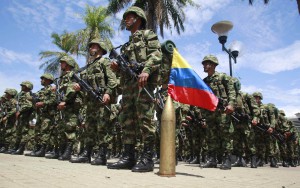 Colombian soldiers stand at attention next to their national flag during an inauguration ceremony for a new mobile brigade set up to fight against the Revolutionary Armed Forces of Colombia, in Florencia