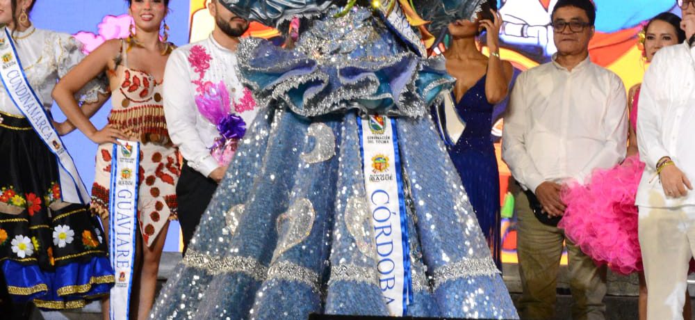 Jania Raquel Osorio, quien fue coronada como la Embajadora Nacional del Folclor. Ella luce un deslumbrante vestido azul de lentejuelas con una corona plateada mientras sostiene un ramo de flores [&hellip;]